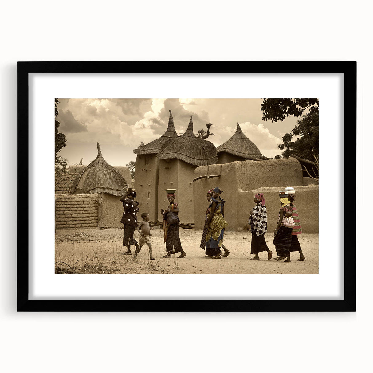 Extra large abstract art print of a Mali scenery in vibrant colors on a textured canvas, framed in black.