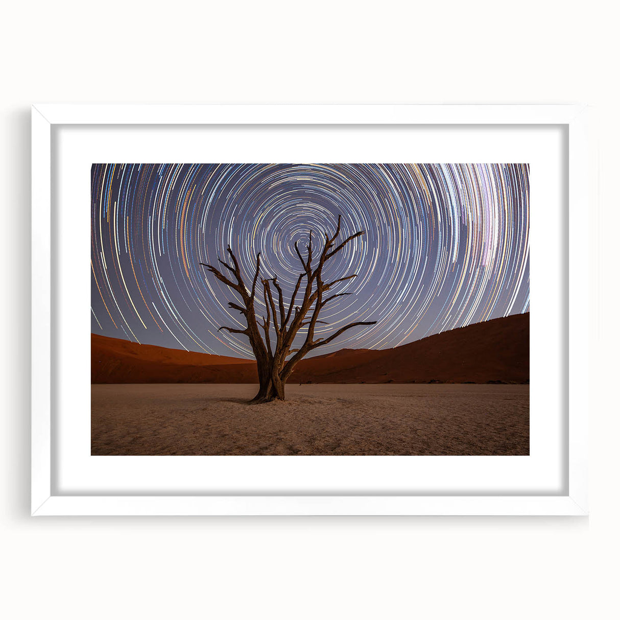 Extra large abstract art print of an African scenery in muted earth tones on a textured canvas, framed in white.