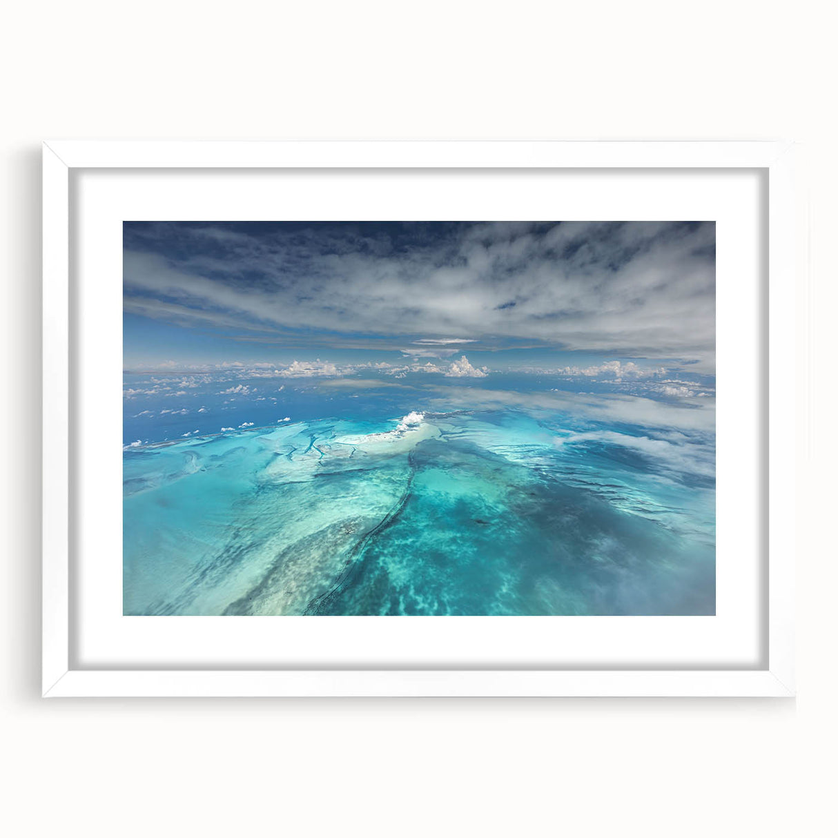 Textured abstract art print depicting Caribbean scenery in muted blue and green tones, framed with a white mat.