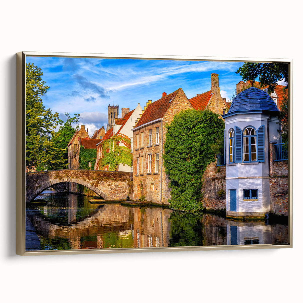 Framed canvas featuring a vintage-style landscape painting of a European scene in muted earth tones.