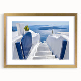 Abstract art print of Santorini with blue and white tones on a framed gold mat, suitable for dining room decor.