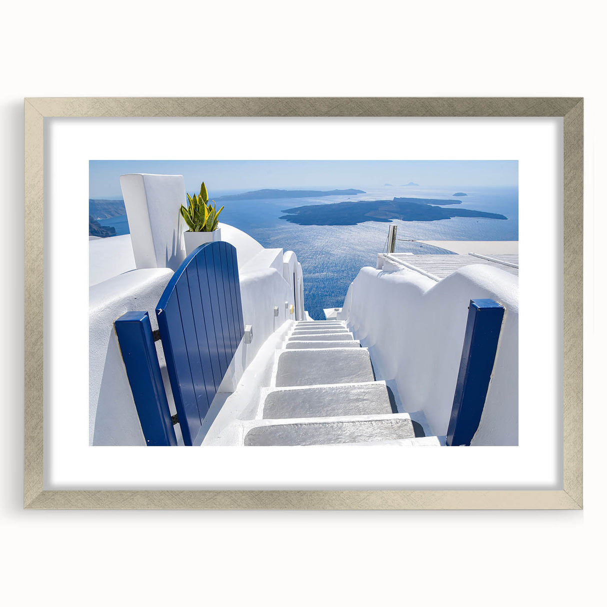 Extra large abstract art print depicting a textured Santorini landscape in muted blues and whites, framed in silver.