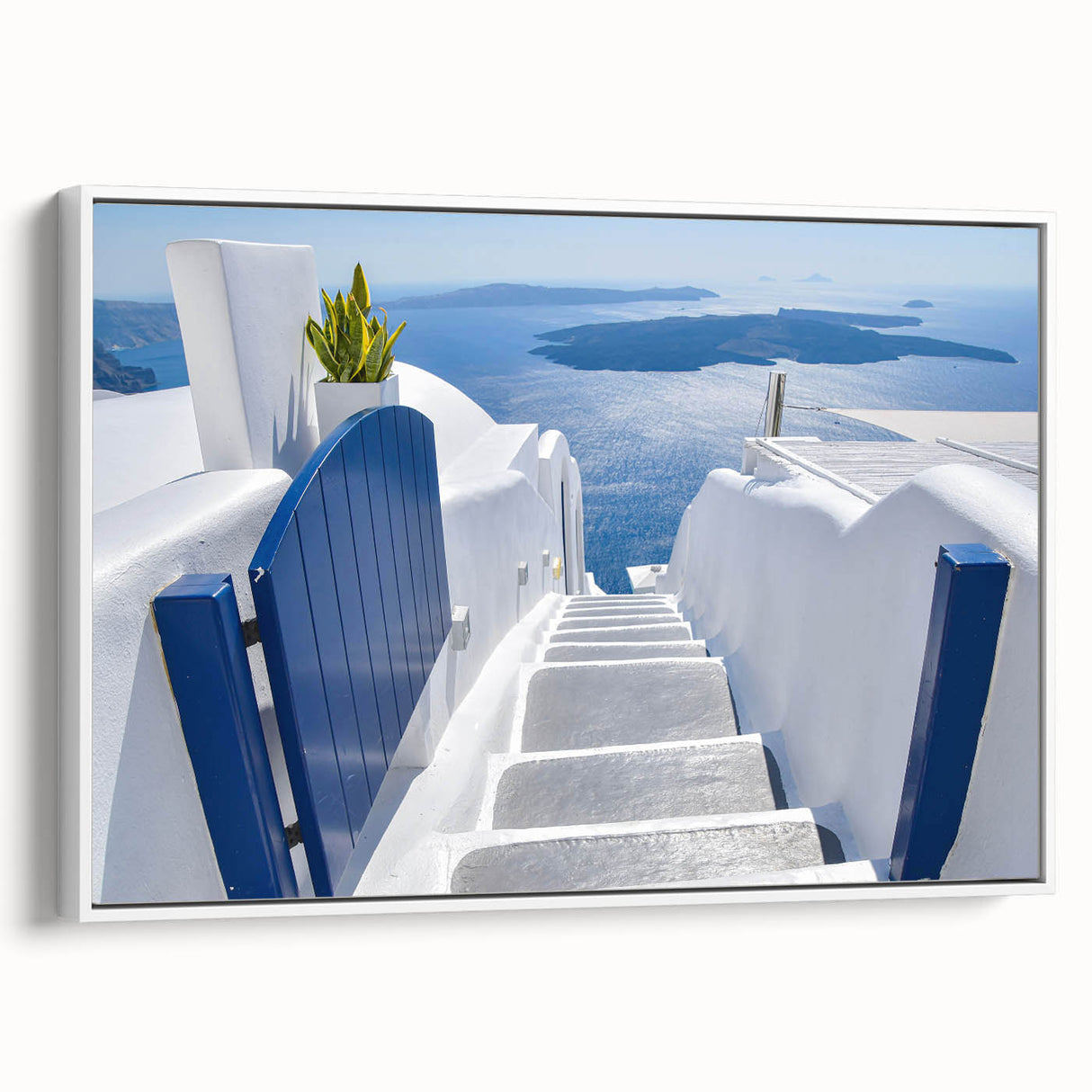 Framed canvas of vintage poster art depicting Santorini, Greece in vibrant hues of blue and white.
