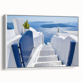 Framed canvas of vintage poster art depicting Santorini, Greece in vibrant hues of blue and white.