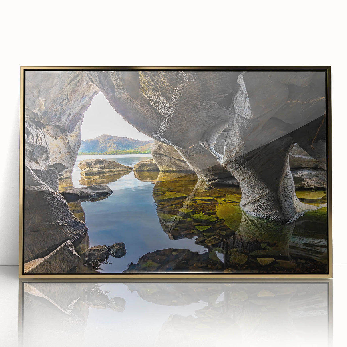 Art deco poster of an Irish landscape in muted greens and browns on acrylic, framed in gold.