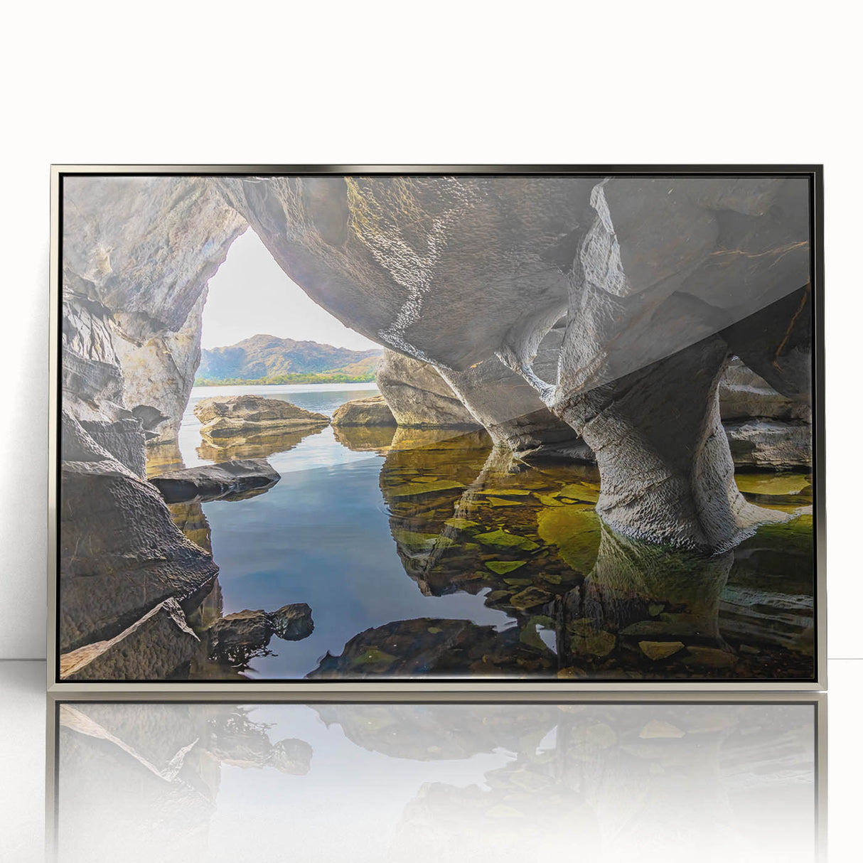 Large art print of a European Irish landscape in muted green and blue tones on a silver-framed acrylic.