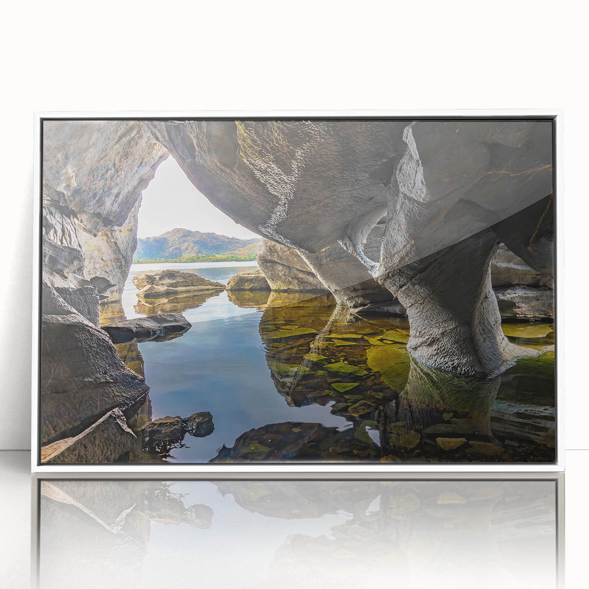 Mid-century modernist art depicting a serene Irish landscape in muted green and blue tones, acrylic print in white frame.