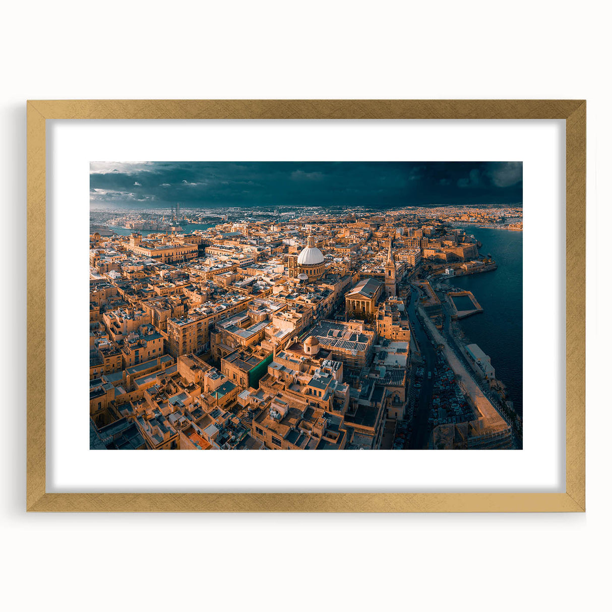 Abstract art print of a European Malta scenery in muted gold and blue tones, framed with a golden mat.