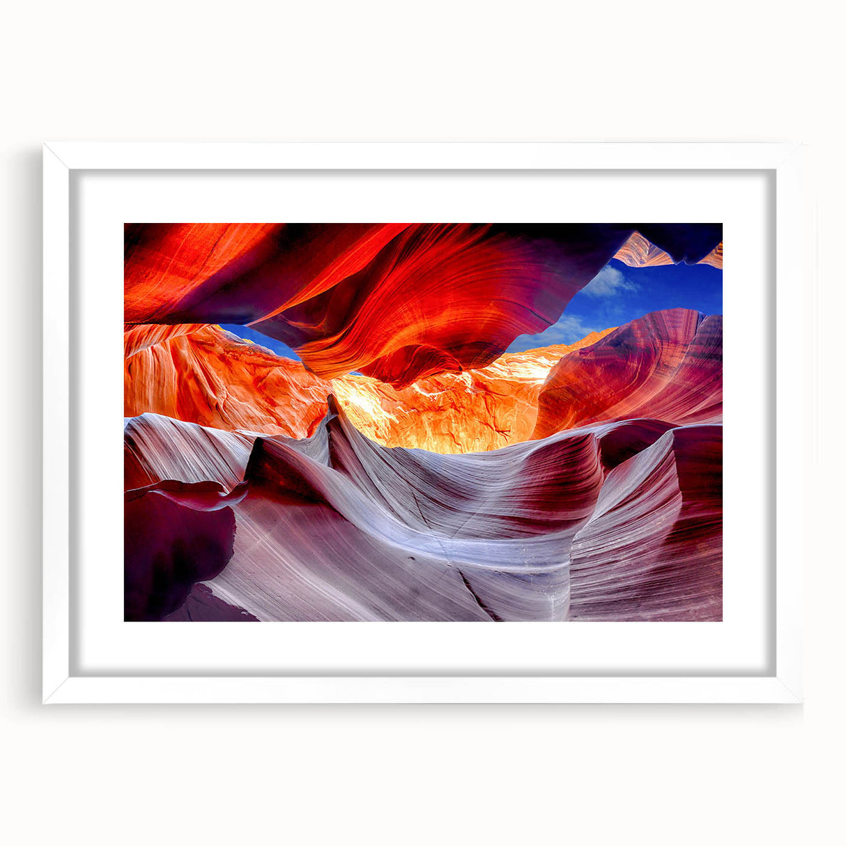 Abstract art print of Antelope Canyon in Arizona, featuring swirling red and orange tones on a framed white mat.