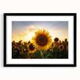 Abstract art print of colorful, textured scenery, framed in black, ideal for living room decor.