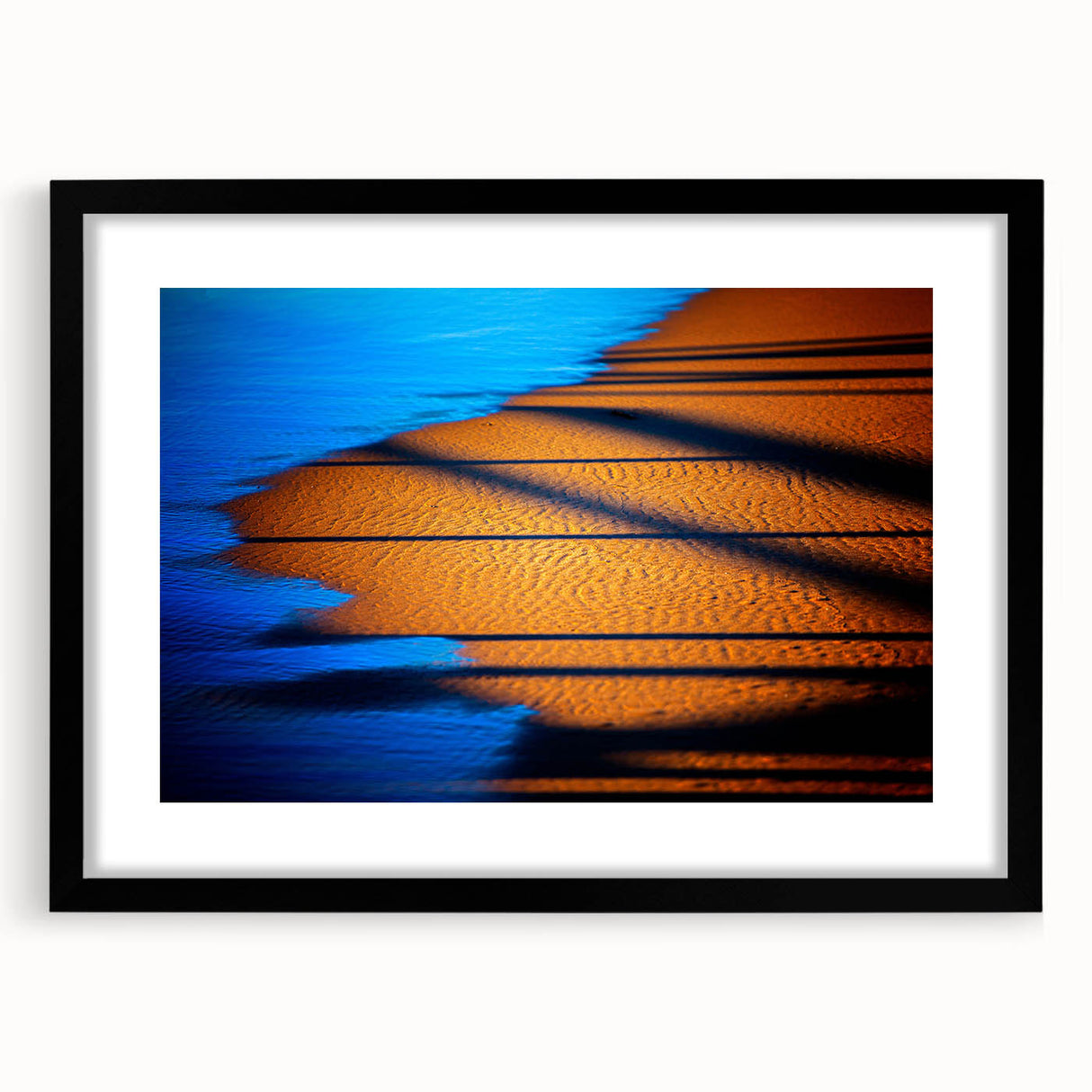 Abstract landscape wall art framed in black with a white mat, showcasing vibrant colors and bold brush strokes, ideal for modern home decor.