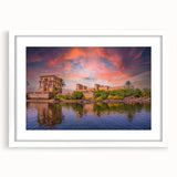 Abstract art print of an Egyptian landscape in textured hues of orange and brown on a large framed canvas.