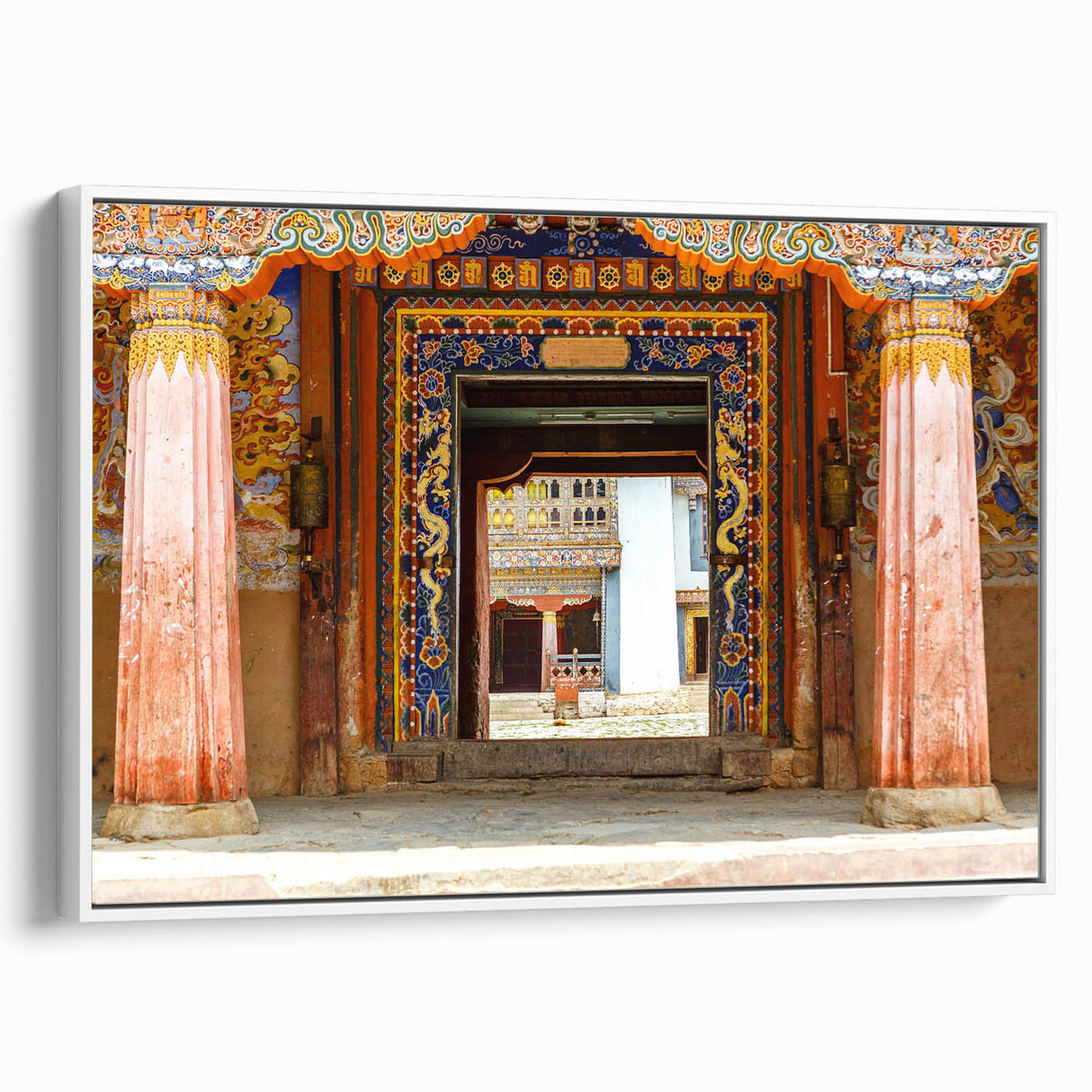 Framed canvas of vintage poster art featuring a Bhutanese landscape in colorful tones, ideal for living room decor.