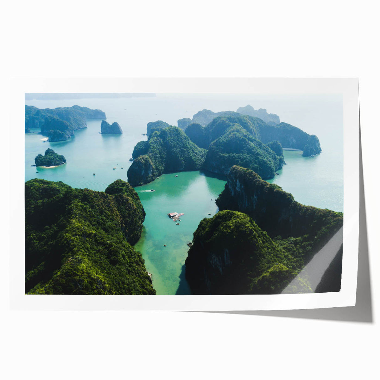 Rolled print of a Vietnamese landscape with lush greenery and a river, in muted earth tones.