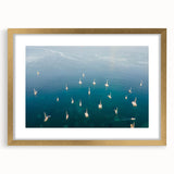 Abstract art print of a Caribbean scenery in muted blue and green tones, framed in gold, ideal for dining room decor.