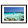 Abstract art print of colorful, textured scenery, set in a black frame, ideal for living room decor.
