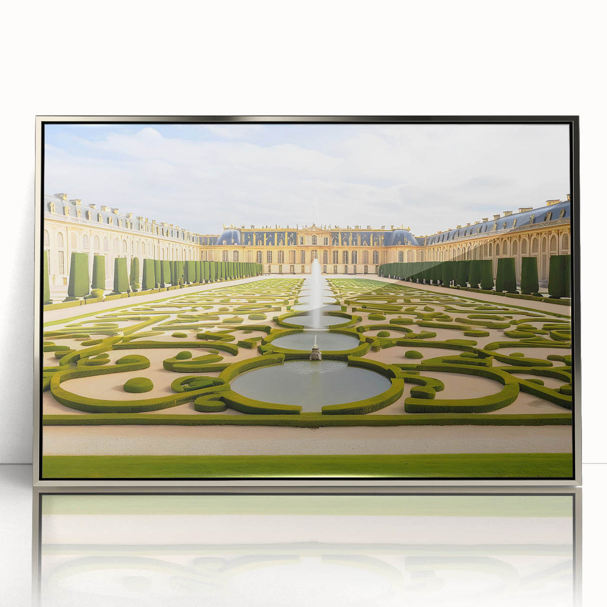 Large art print of the Versailles palace in muted gold and green tones, framed in silver acrylic.