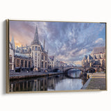 Framed canvas featuring a vintage-style landscape painting of a European scene in black and gold tones.