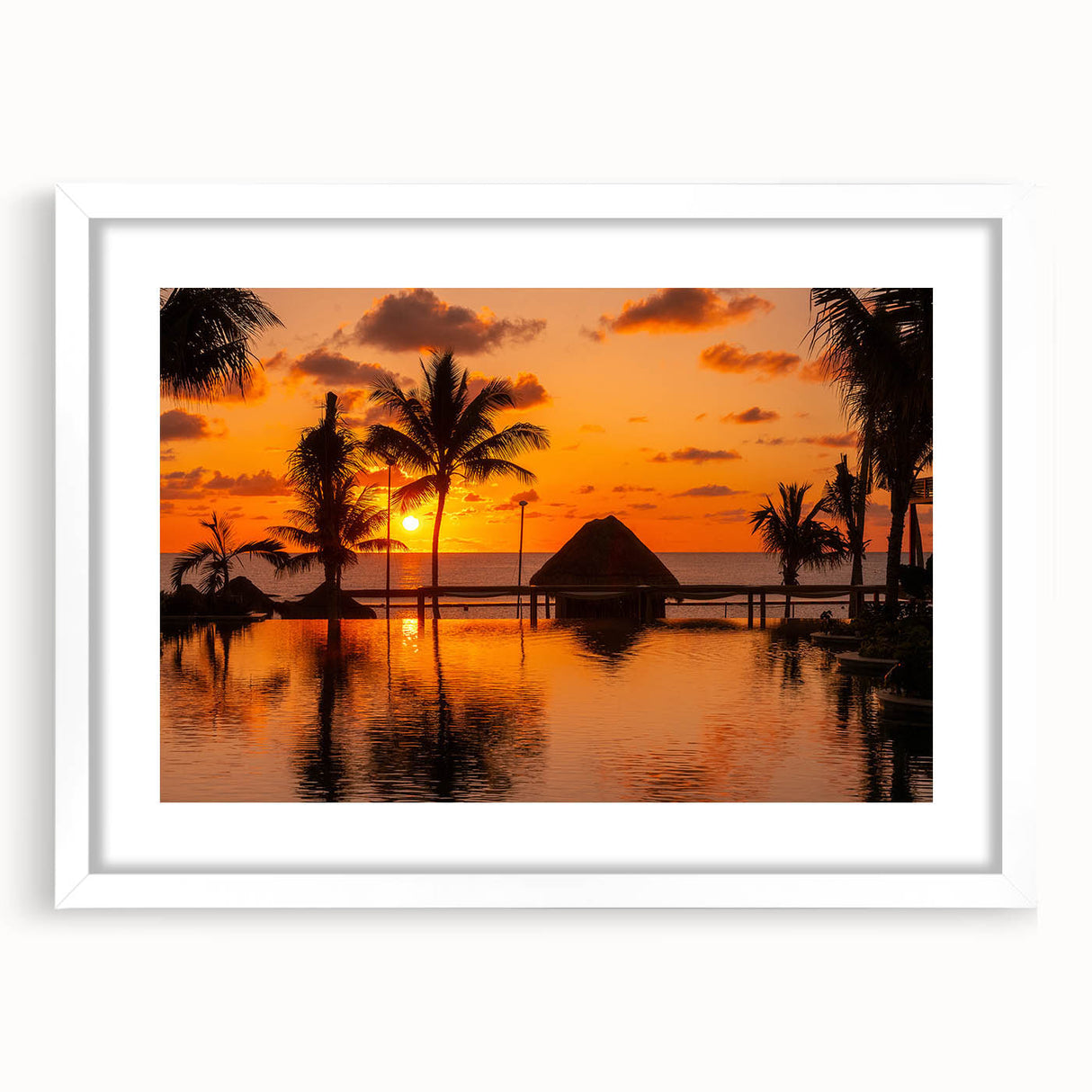 Abstract art print of Cancun scenery in muted blue and green tones, framed with a white mat, suitable for dining room decor.