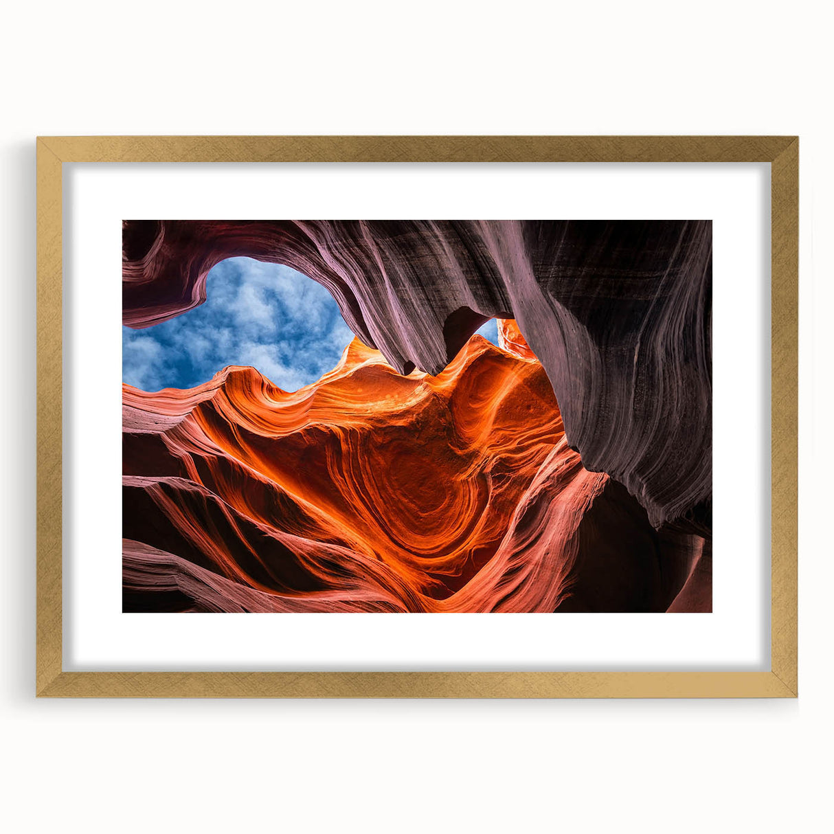 Extra large abstract art print of Arizona's Antelope Canyon in gold frame, featuring textured red and orange hues.