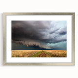 Textured art print depicting abstract Kansas scenery in muted earth tones on a framed silver mat, suitable for bedroom decor.