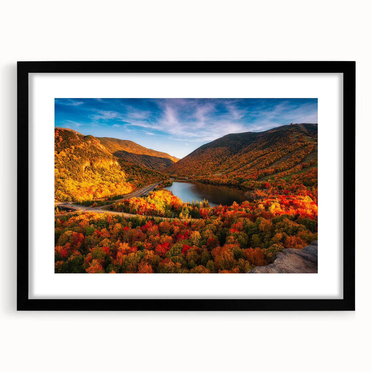 Colorful abstract art print of a textured New Hampshire scenery in a large black frame, ideal for living room decor.