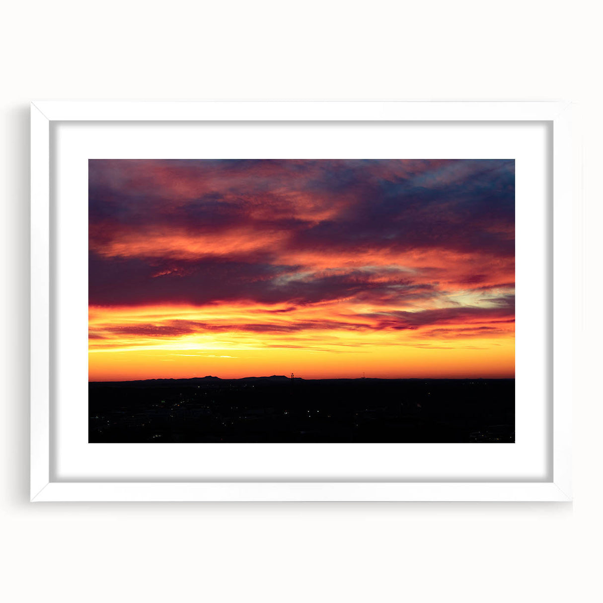 Abstract art print of Charlotte skyline in muted gray and blue tones on a white framed canvas.