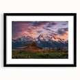 Colorful abstract art print of the Grand Tetons, featuring vibrant hues on a textured canvas, framed in black.