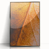 Mid-century modernist art depicting autumn trees in earth tones on a silver-framed acrylic print.