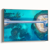 Framed canvas artwork depicting a serene landscape with a bridge, featuring a silver frame. The piece highlights tranquil colors and detailed textures, perfect for home decor.