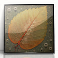 Framed wall art showcasing a vibrant floral and botanical design, featuring green leaves and colorful flowers, displayed against a sleek black frame, perfect for modern home decor.