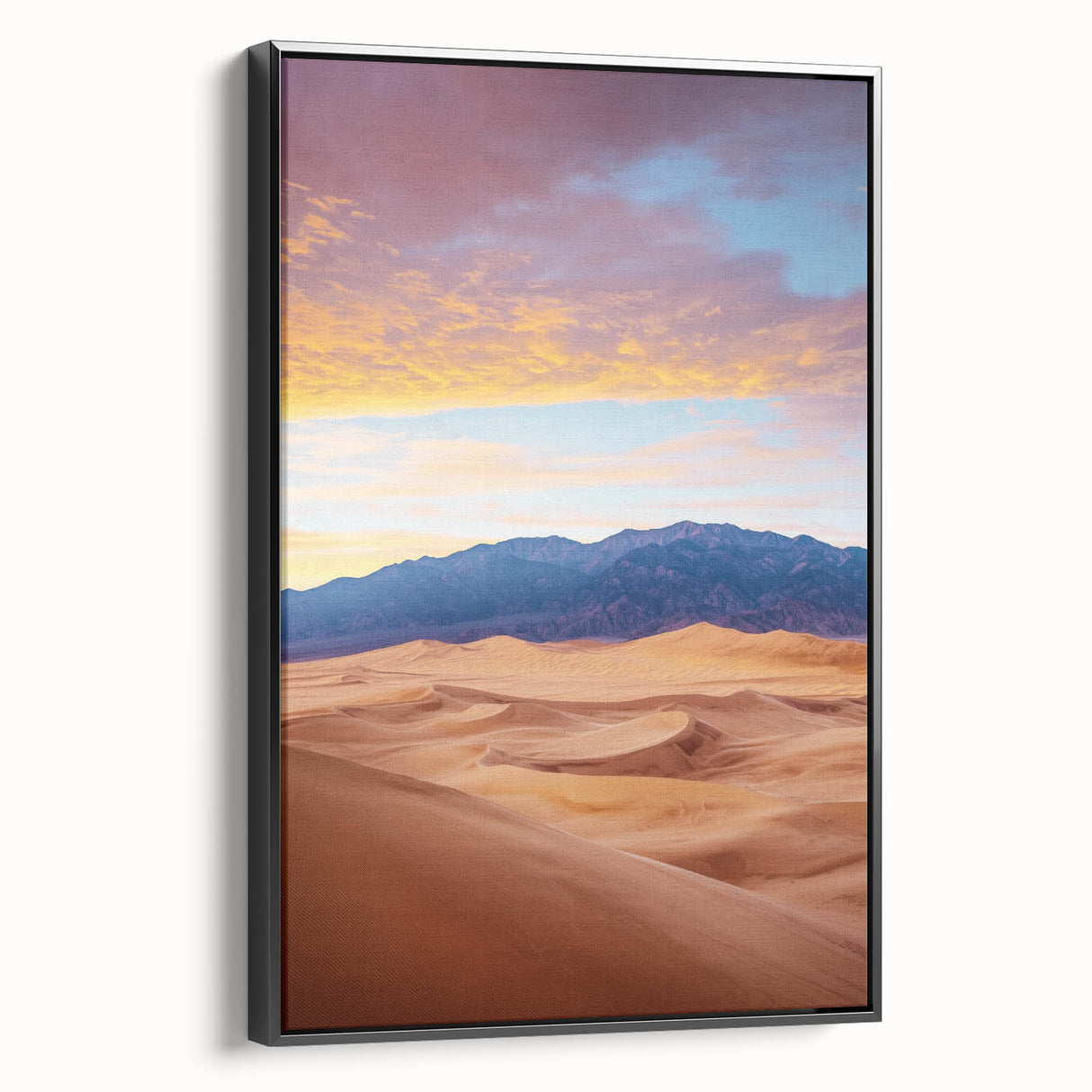 Framed canvas wall art depicting a serene desert landscape with rolling sand dunes, featuring a sleek black frame, ideal for modern home decor.