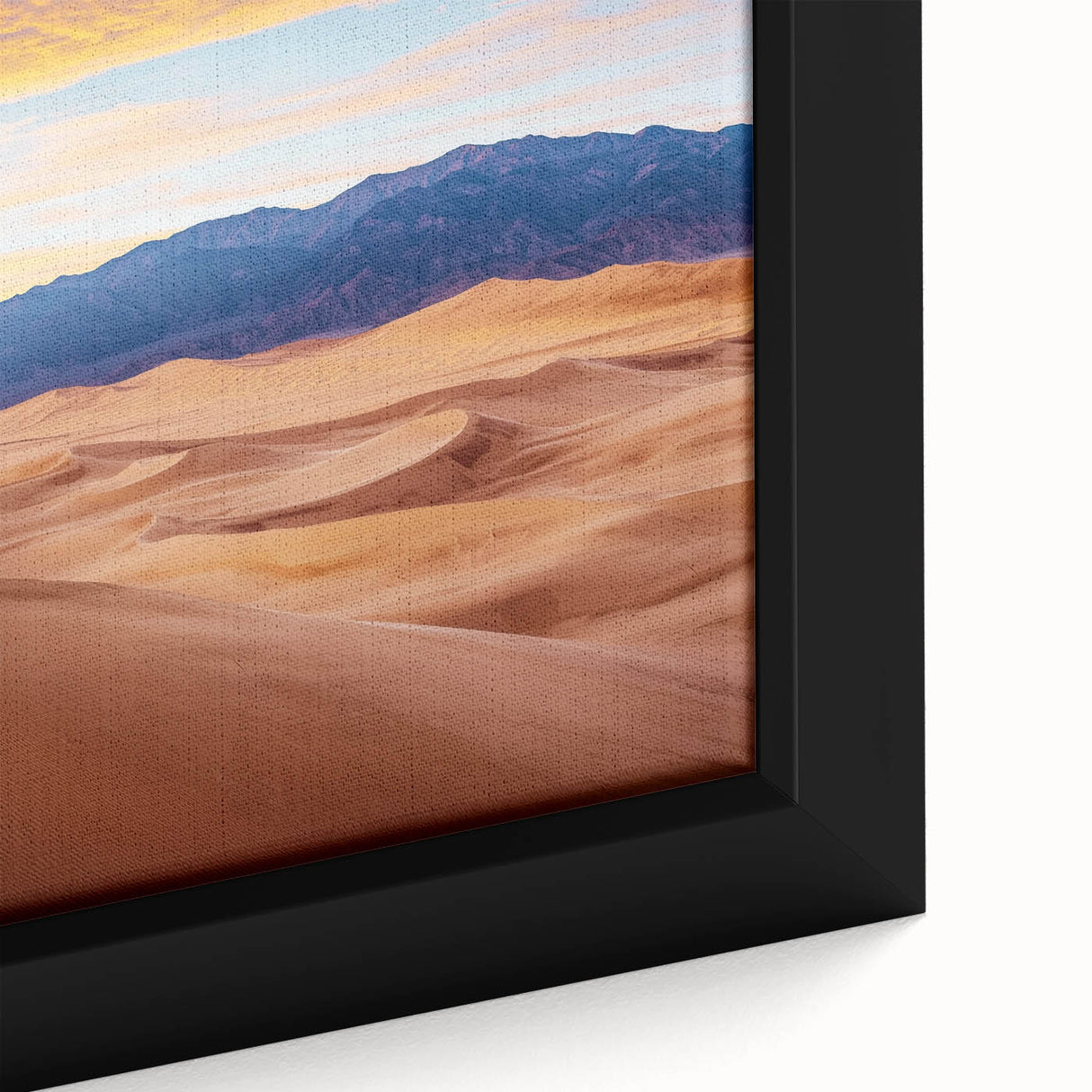 Close-up of a framed canvas depicting serene sand dunes at sunset, showcasing warm golden and orange hues, ideal for home decor or artistic inspiration.