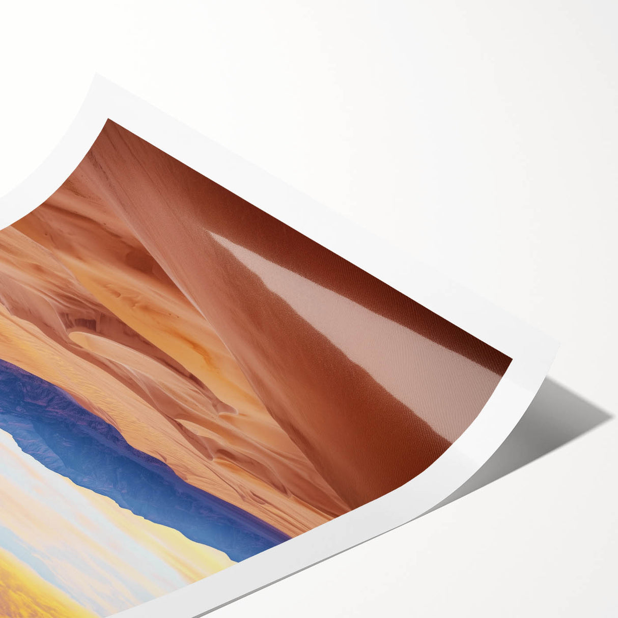 Desert landscape print depicting rolling sand dunes under a clear blue sky, elegantly rolled and packaged in a protective cardboard tube for easy transport.