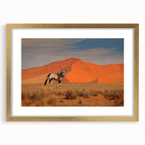 Textured abstract art print depicting a serene African landscape in muted earth tones, framed in gold, ideal for bedroom art.