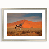 Abstract art print of a Namibian landscape in muted earth tones on a framed silver mat, ideal for dining room decor.