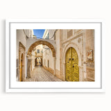 Abstract art print depicting Tunisian scenery in muted earth tones on a framed white mat.