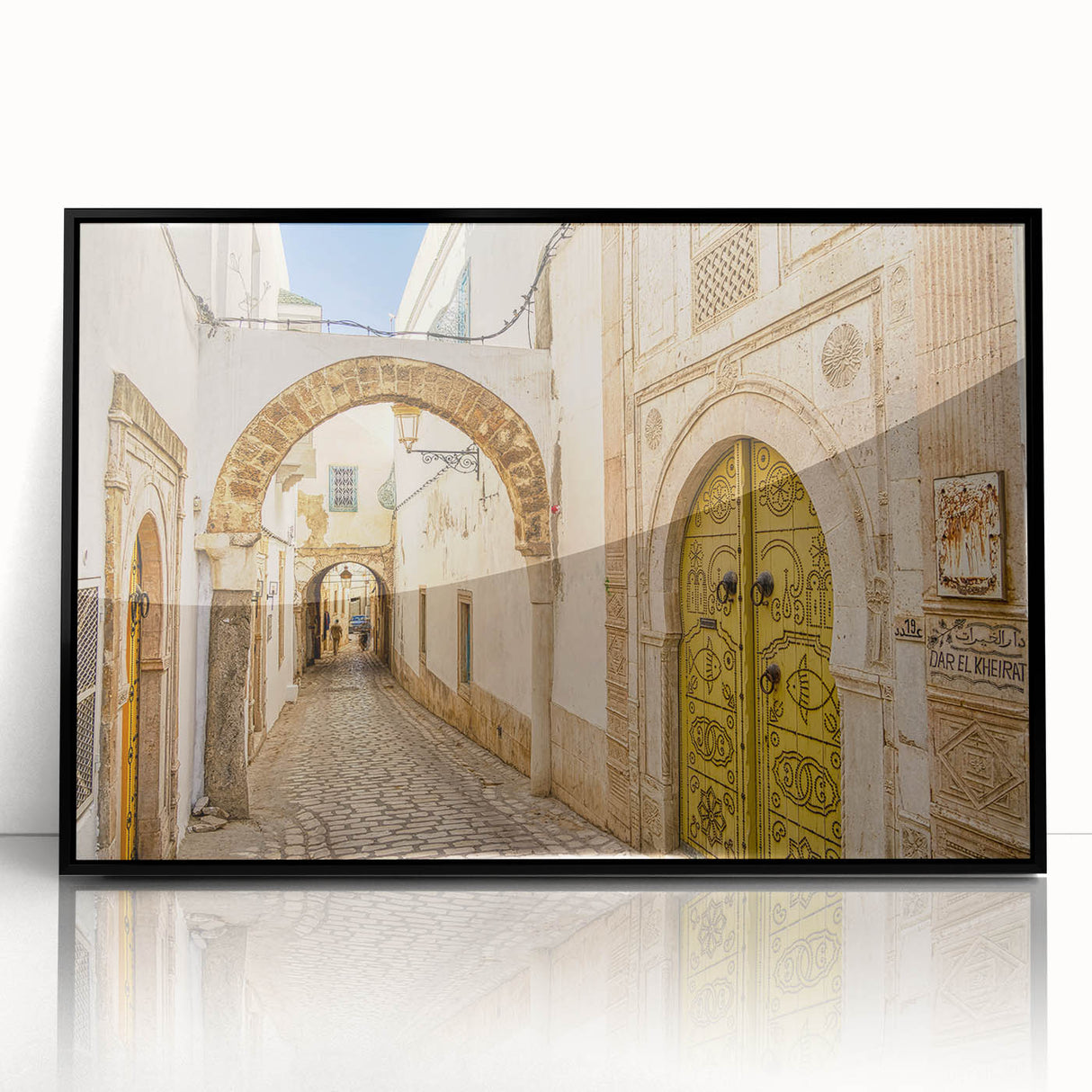 Large abstract wall art depicting a Tunisian landscape in muted earth tones, framed in black acrylic.