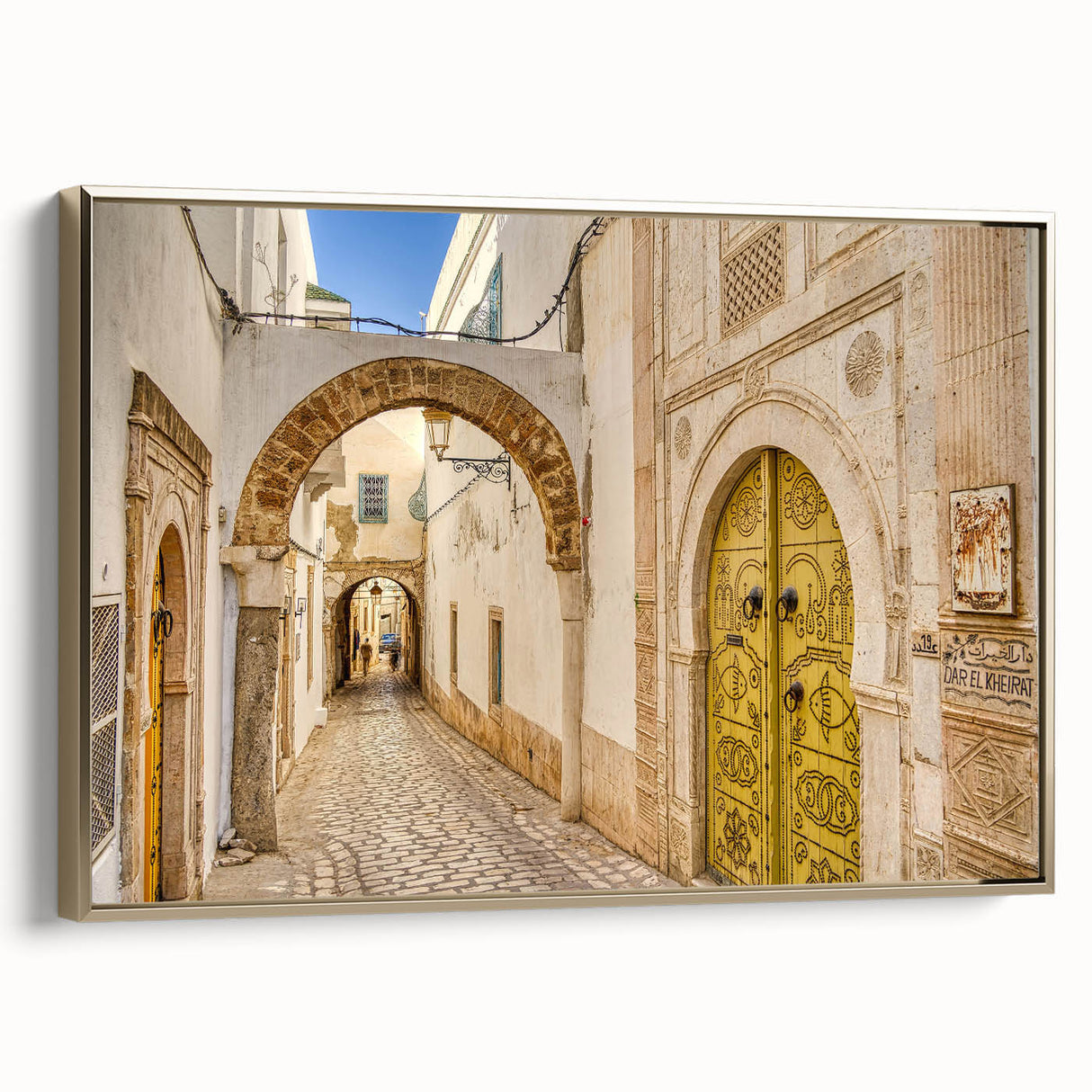Framed canvas landscape art of a Tunisian scene in muted earth tones, ideal for bedroom wall decor.
