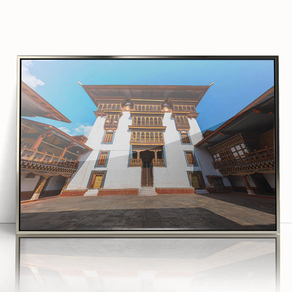 Mid-century modernist art of Bhutan scenery in silver framed acrylic, featuring muted earth tones.