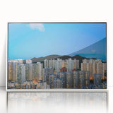Framed acrylic print of a Hong Kong skyline in art deco style, featuring muted gray and blue tones.