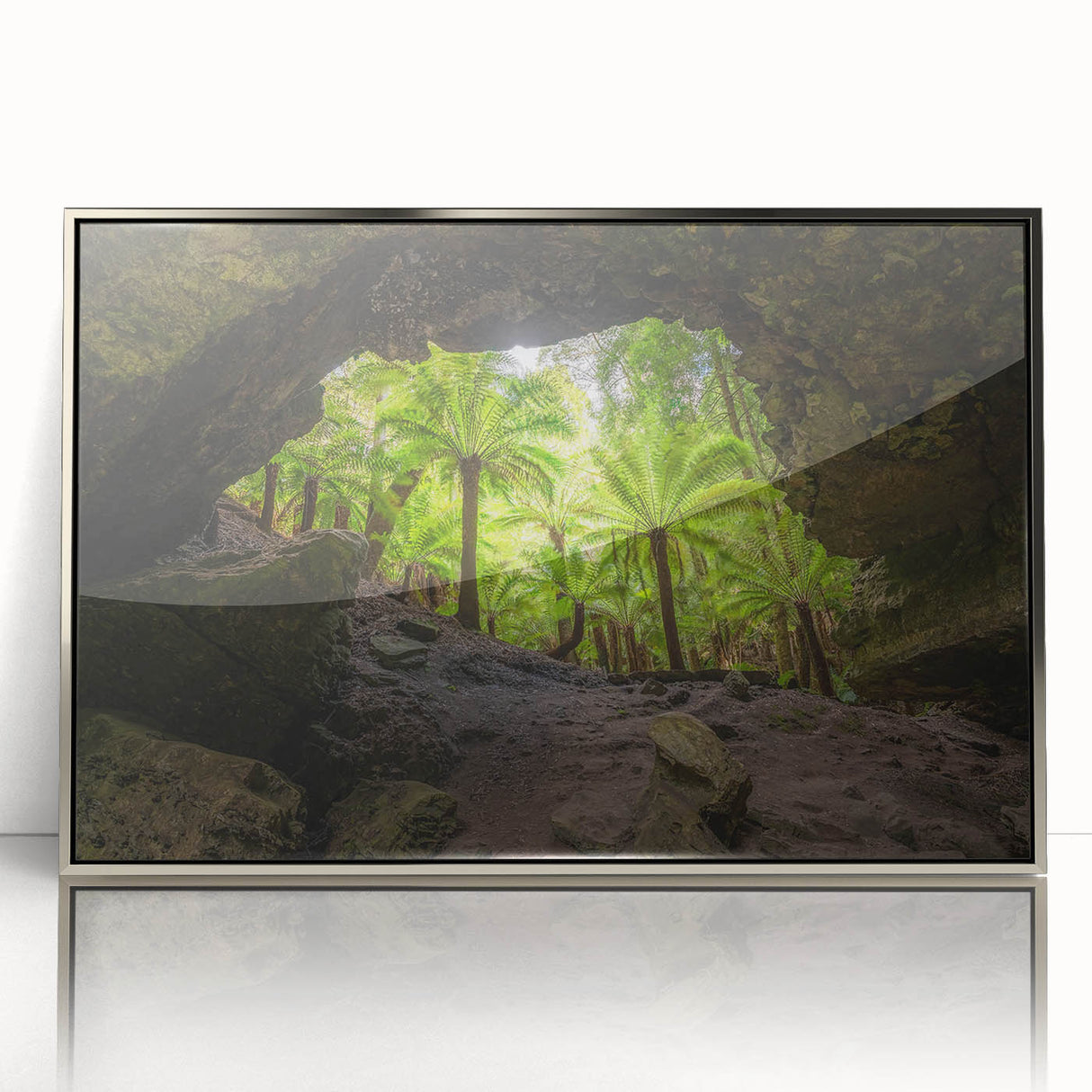 Large art print of a Tasmanian landscape in muted green and blue tones on a silver-framed acrylic.