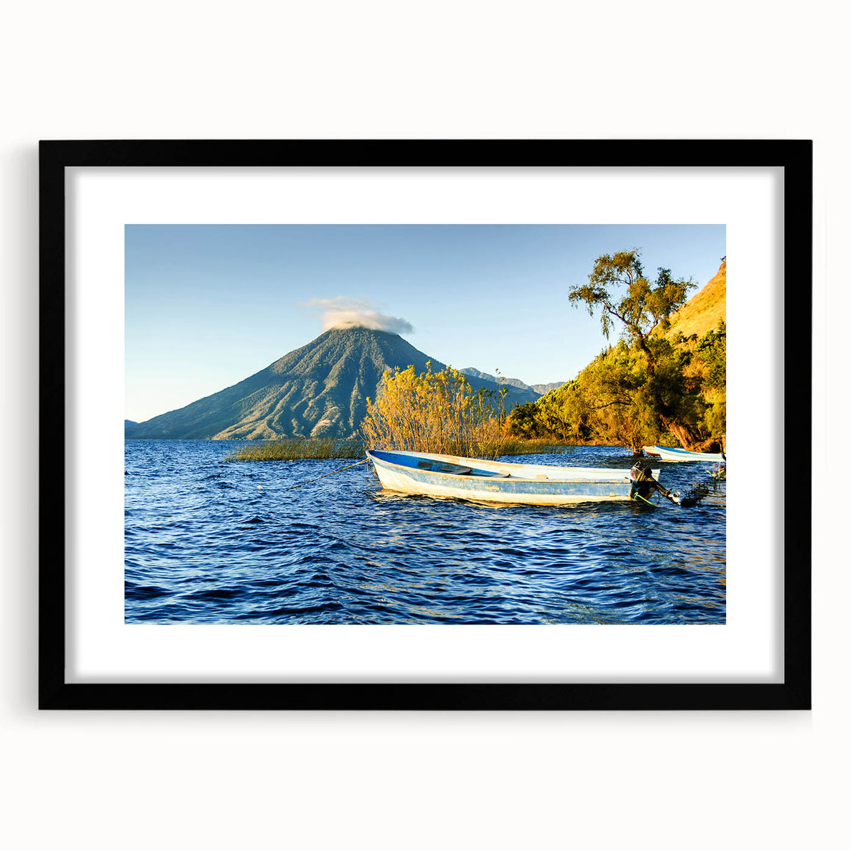 Abstract art print of Central American scenery in muted earth tones, framed with a black mat, suitable for dining room decor.