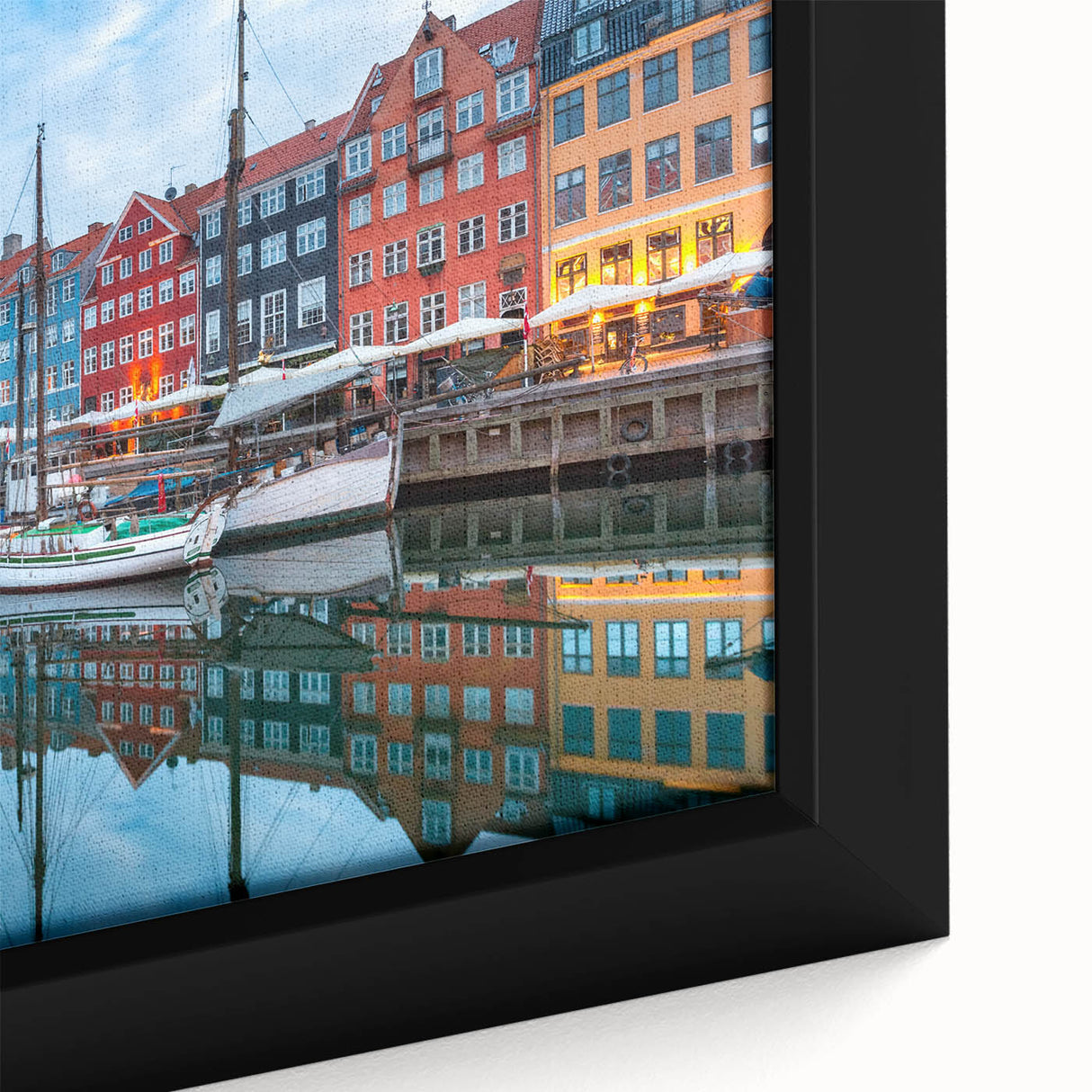 Close-up of a black framed canvas featuring a textured, colorful European scenery, ideal for living room decor.