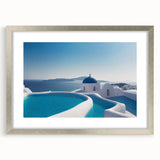 Abstract art print of Santorini with blue and white hues on a framed silver mat, suitable for dining room decor.