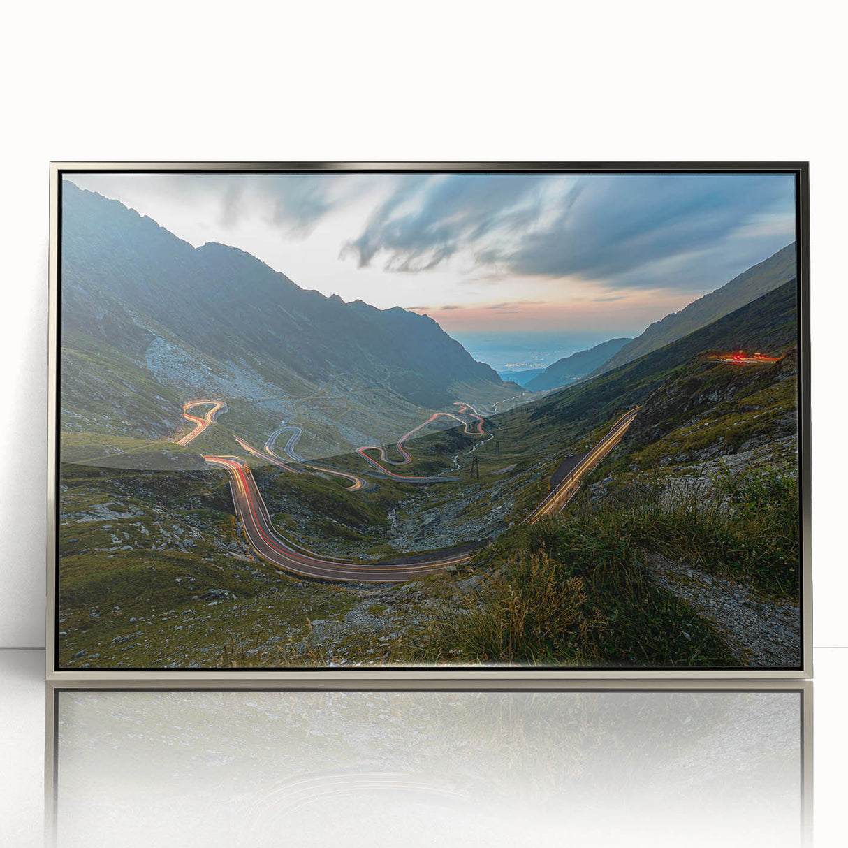 Large art print of a European Romanian landscape in muted earth tones on a silver-framed acrylic.