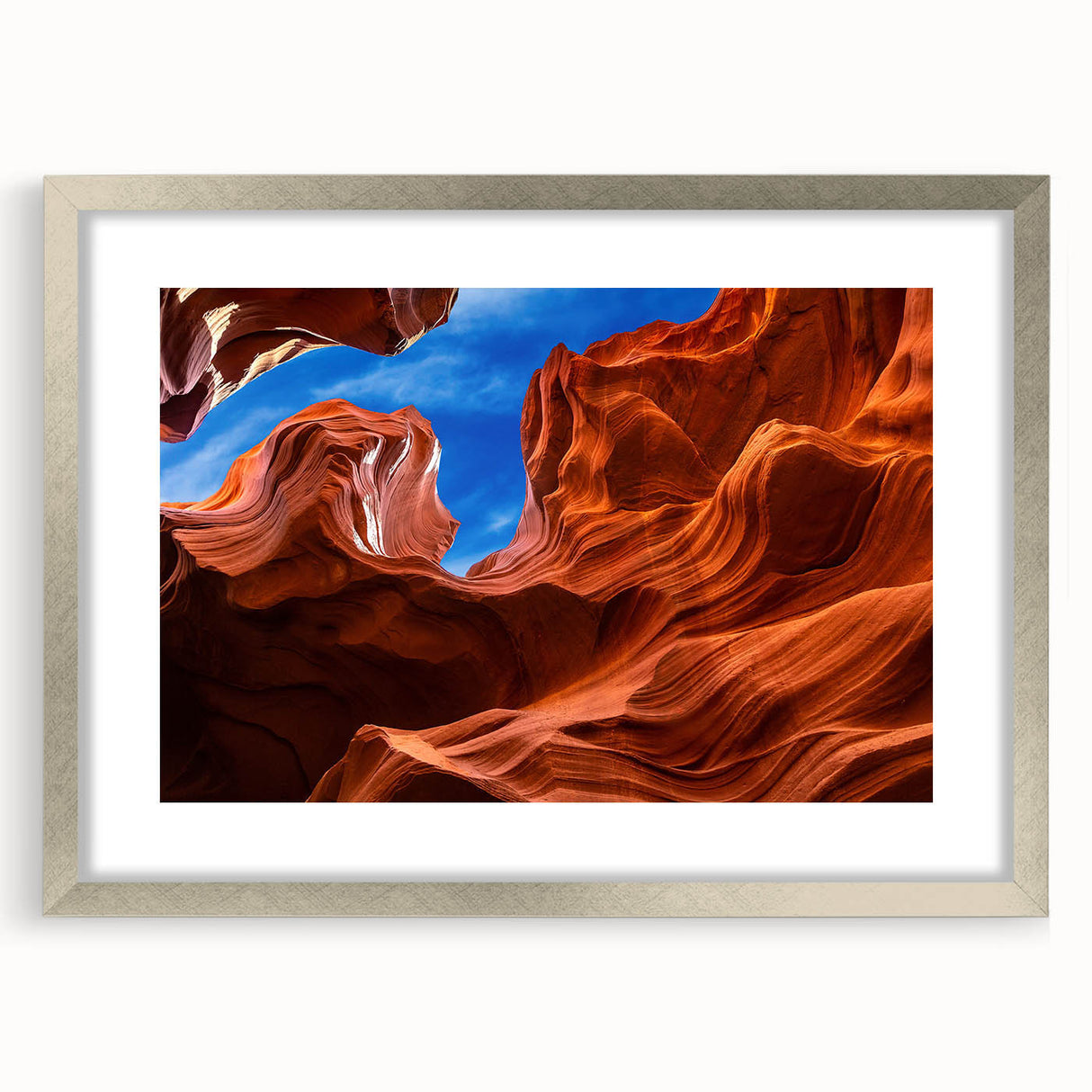 Textured art of Arizona's Antelope Canyon in muted earth tones on a framed silver mat, suitable for bedroom decor.