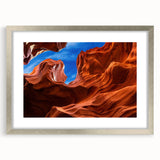 Textured art of Arizona's Antelope Canyon in muted earth tones on a framed silver mat, suitable for bedroom decor.