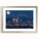 Textured art print of abstract Los Angeles skyline in muted gray and blue tones, framed in silver.