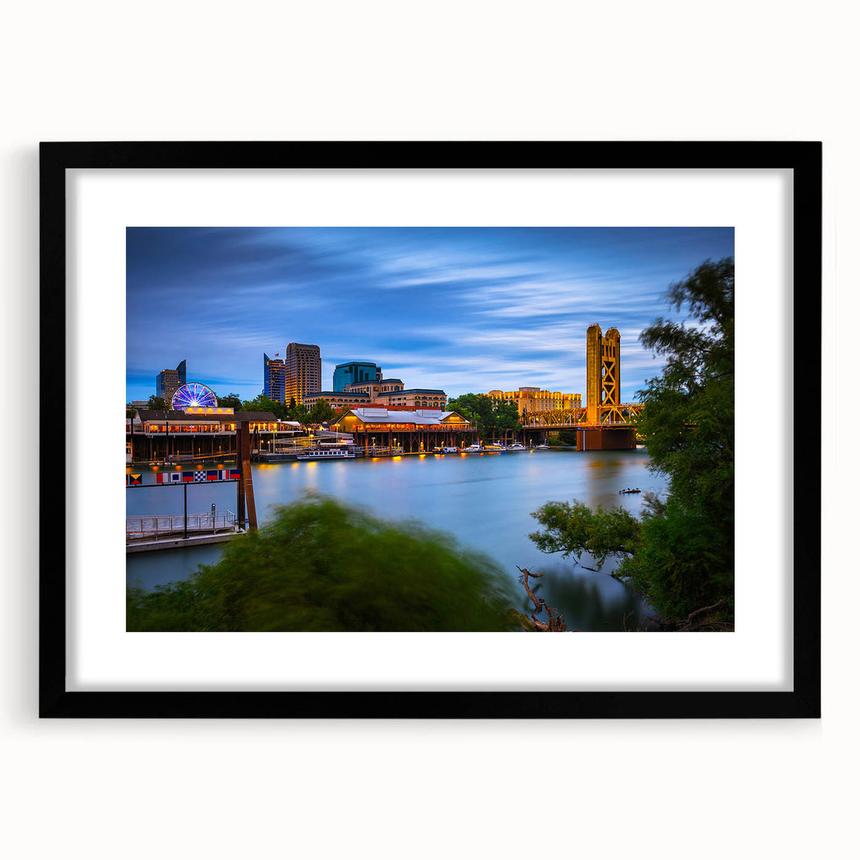 Abstract art print of colorful, textured scenery depicting Sacramento, in a large black frame with mat.